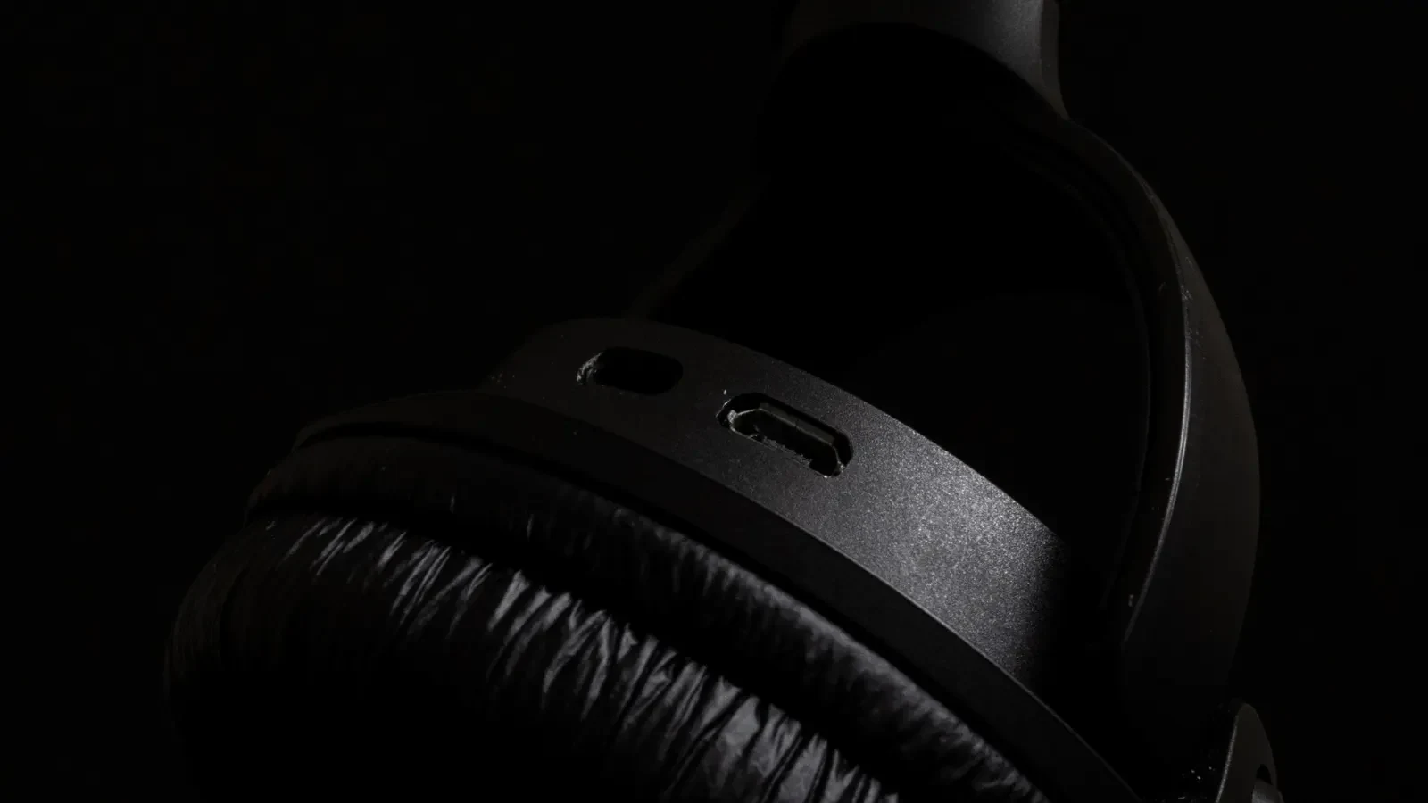Close-up of a black headphone ear cushion against a dark background
